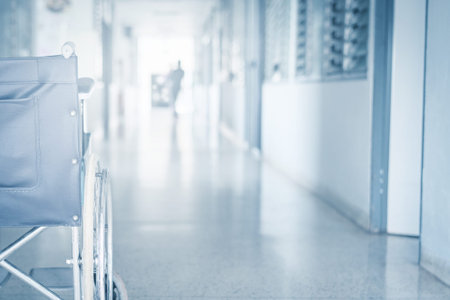 Empty wheelchair parked in hospital pathway blurred with patient walk in hospital .の写真素材