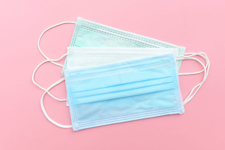 Medical face mask, Medical protective mask on pink background. Disposable surgical face mask cover...