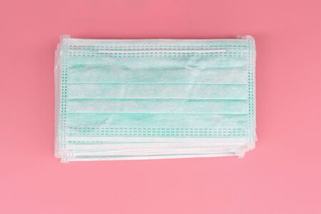Heap Medical face mask, Medical protective mask on pink background. Disposable surgical face mask cover the mouth and nose. protect Healthcare and medical conceptの写真素材