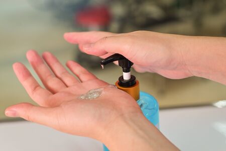 Hand sanitizer, Close up Woman hands using alcohol hand sanitizer gel dispenser prevention bacteria coronavirus, Selective focus Shallow DOF.の写真素材