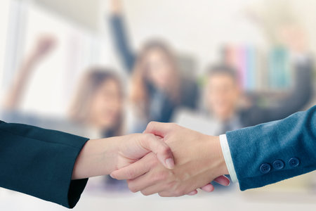 Business handshake with partnership on blurred business people successful concept coworkers...