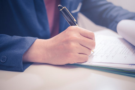 Asian Businessman checking and signing in business finance reports or business billing accounting closeupの写真素材