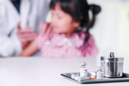 Vial of Covid-19 vaccine ,give COVID-19 vaccine injection for child can help reduce the transmission of the new coronavirus from kid to person before go to schoolの写真素材