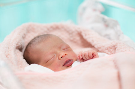 newborn baby face closeup Sleeping in table in hospitalの写真素材