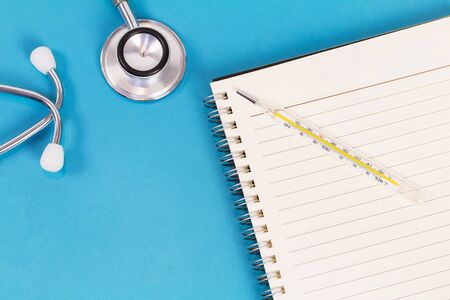 Empty paper and medical equipment on blue background. Copy space.の写真素材