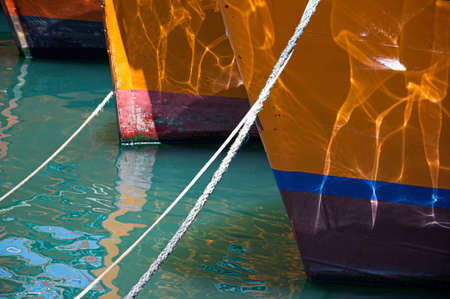 Bows of fishing boats in the harborの写真素材