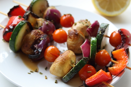 Vegetable skewers on white plate.の写真素材