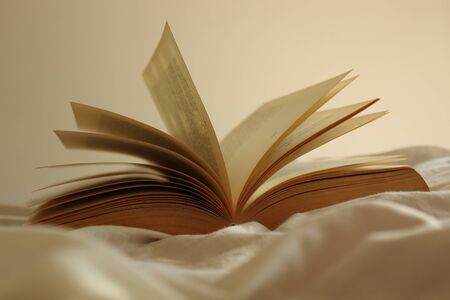 Open book on a bed.の写真素材