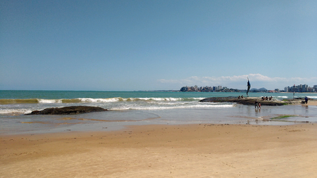 Guarapari beach with yellow sands and rocksの写真素材