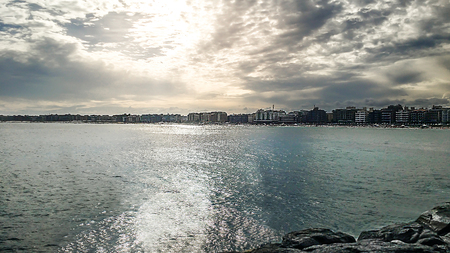 Sunset over the city of cold cape on the horizonの写真素材