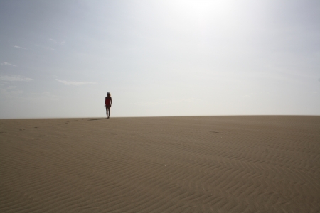 Woman standing fierce in desert の写真素材
