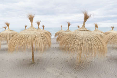 umbrellas for the sun on the beach of the mediterranean sea, Malaga. Andalusia, Spainの写真素材