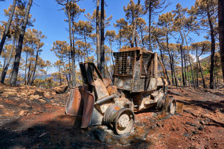 Heavy machinery burned by fire in the Jubrique fire next to Sierra Bermaja in the Genal Valley, Malaga. Andalusia, Spain. September 2021の写真素材