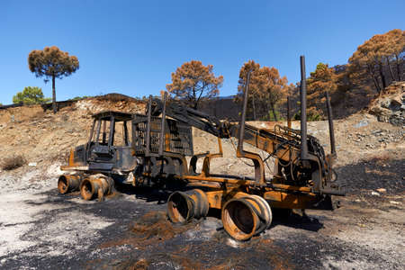 Heavy machinery burned by fire in the Jubrique fire next to Sierra Bermaja in the Genal Valley, Malaga. Andalusia, Spain. September 2021の写真素材