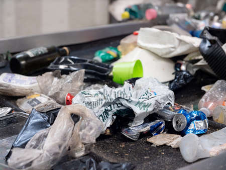 Plastic waste on a conveyor belt in a waste management plantの写真素材
