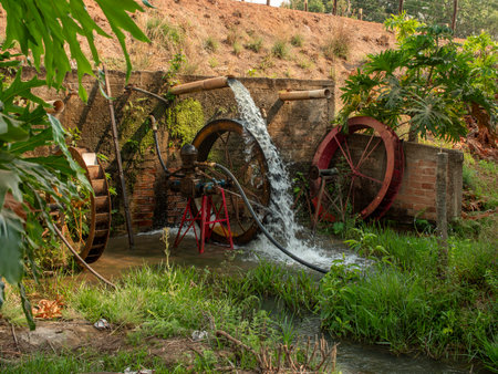 This is a mechanical water pump that is used for delivering drinking water to livestock on the fieldの写真素材