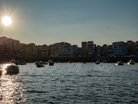 Sunset over the Spanish fishing village Fisterra in Galiciaの写真素材