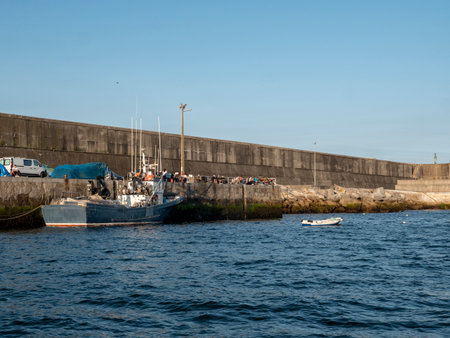 Fishing boat is moored in the Spanish fishing Village Finisterreの写真素材