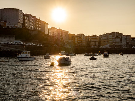 Sunset over the Spanish fishing village Fisterra in Galiciaの写真素材
