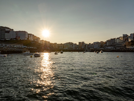Sunset over the Spanish fishing village Fisterra in Galiciaの写真素材