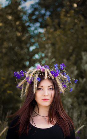 Photo of girl in purple floral wreaths on bokeh backgroundの写真素材