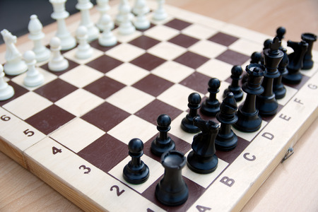 A photo of a chessboard with chess pieces on it from the side of black figuresの写真素材