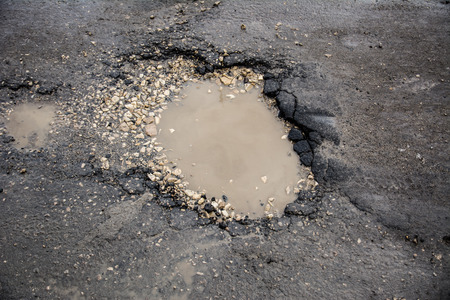 Road defect on the asphalt roadの写真素材