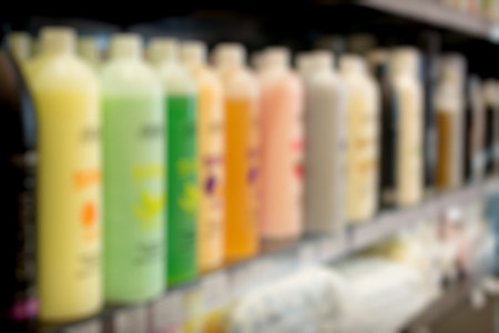 Blurred store shelf with cosmetic products for use as a background