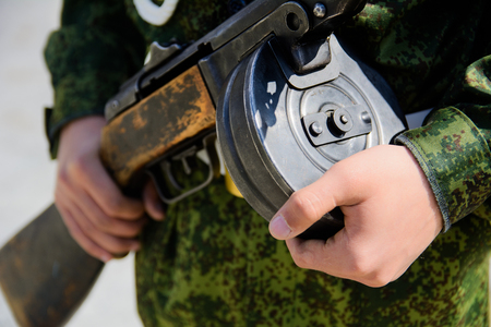 The submachine gun Shpagin in the hands of a soldier close-up with a selective focus with a shallow depth of fieldの写真素材
