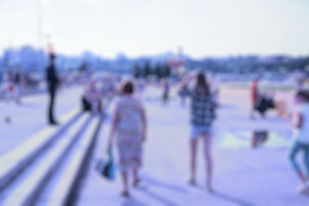 Blur abstract people background, unrecognizable silhouettes of people walking on a streetの写真素材