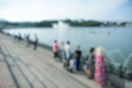 Blur abstract people background, unrecognizable silhouettes of people walking on a streetの写真素材