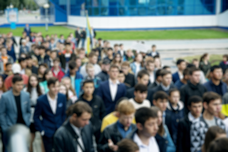 Blur abstract people background, unrecognizable silhouettes of people walking on a streetの写真素材