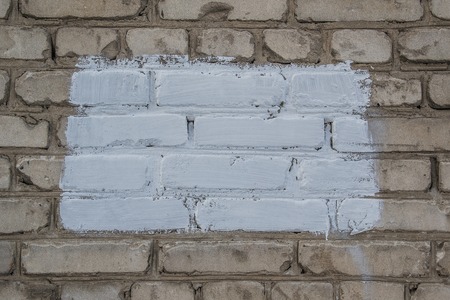 White brick wall with a white spot, background, textureの写真素材