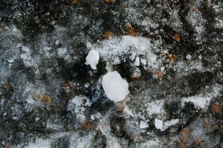 Texture of broken ice on asphalt. A good background of frozen waterの写真素材