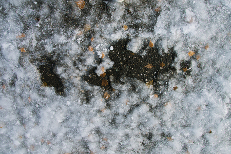 Texture of broken ice on asphalt. A good background of frozen waterの写真素材