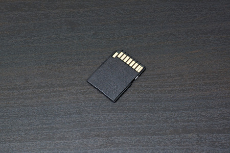 SD card for camera. On wooden dark tableの写真素材