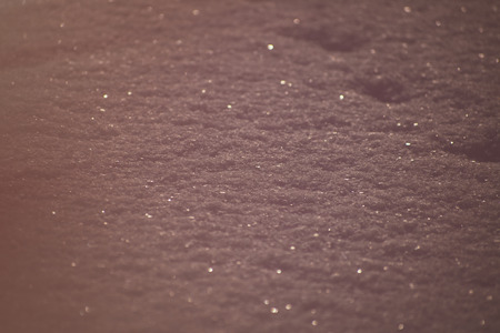 High angle view of snow texture. Winter background. Pink toningの写真素材