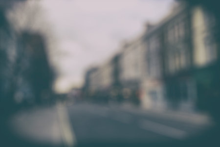 Blurred cityscape background scene. Retro background with stylized filmの写真素材