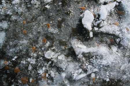 Texture of broken ice on asphalt. A good background of frozen waterの写真素材