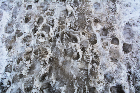 Texture footprints in dirty snowの写真素材