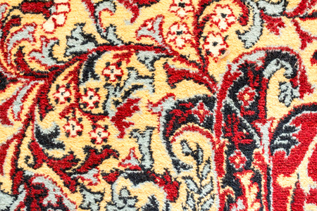 Fragment of retro tapestry fabric pattern with colorful floral ornament on white background.の写真素材
