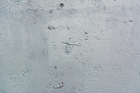 Texture of the surface of an old antique wall with a plaster layer destroyed from moisture, a lot of cracks, irregularities, blisters on the wall, abstract backgroundの写真素材
