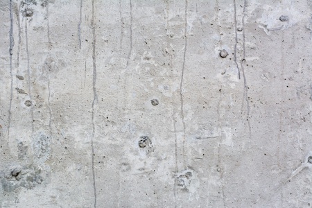 Texture of the surface of an old antique wall with a plaster layer destroyed from moisture, a lot of cracks, irregularities, blisters on the wall, abstract backgroundの写真素材