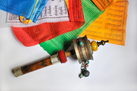 Hand Prayer Wheel and mantra flags of Tibetan Buddhism