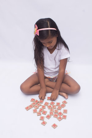 black girl in white shirt playing, photo with white background.の写真素材