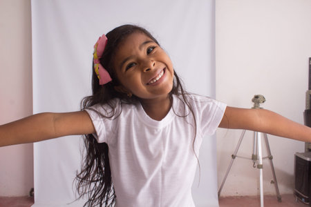 black girl in white shirt playing, photo with white background.