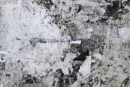 Old bulletin board with rests of paperの写真素材