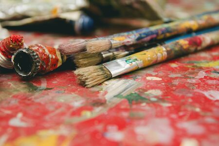 Old oil painting tubes and paintbrushesの写真素材