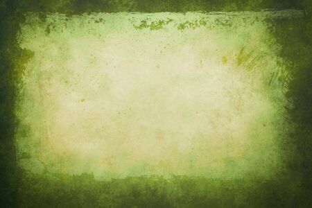 Green grungy backdrop with dark bordersの写真素材