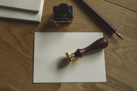 Blank paper, fountain pen, seal and ink on the wooden deskの写真素材